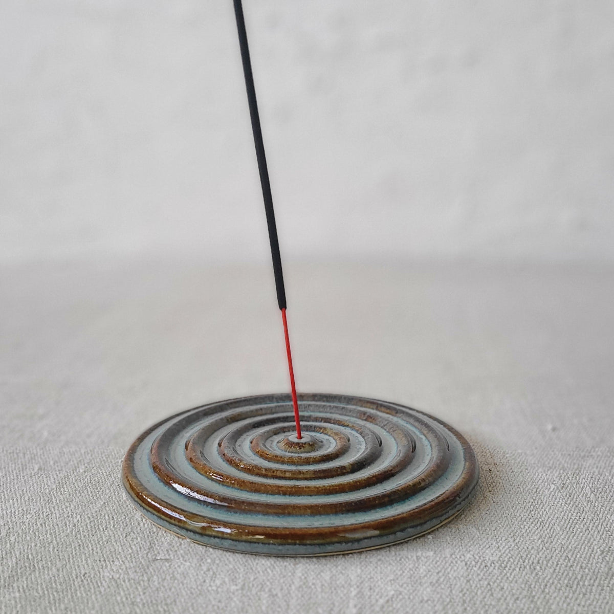 Seafoam blue ceramic incense burner with a classic design by Katie L Thompson Designs, featuring a rounded shape and decorative openings.