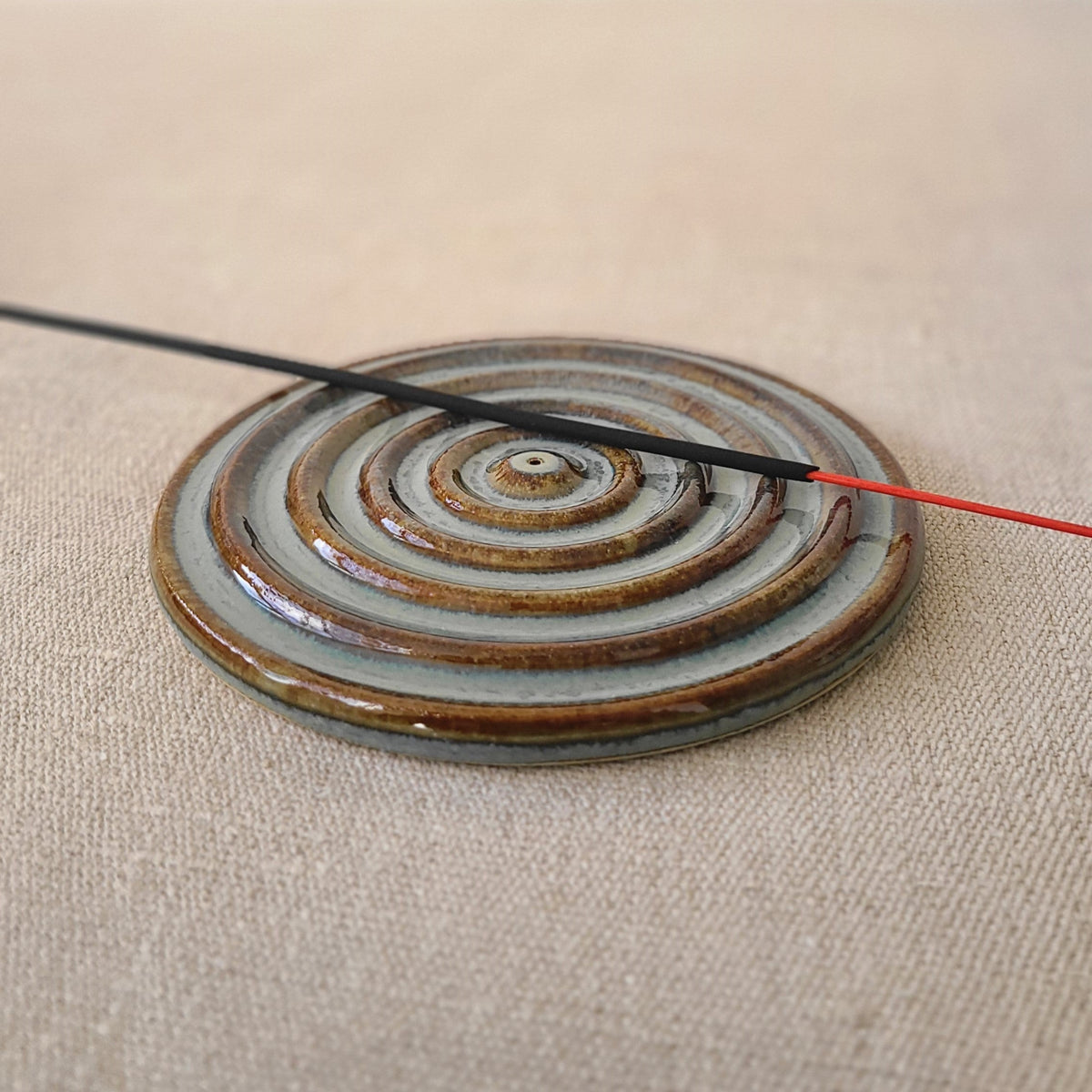 Seafoam blue incense burner with a circular design and a stick holder, crafted by Katie L Thompson Designs.