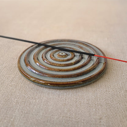 Seafoam blue incense burner with a circular design and a stick holder, crafted by Katie L Thompson Designs.
