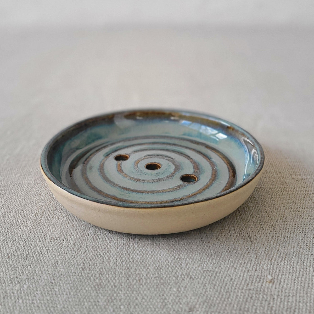 Seafoam blue ceramic soap dish from Katie L Thompson Designs with a simple, elegant design for holding soap.