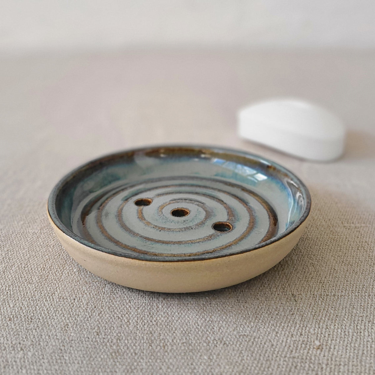 Seafoam blue ceramic soap dish with a bar of soap, designed by Katie L Thompson Designs, featuring a classic, elegant style.