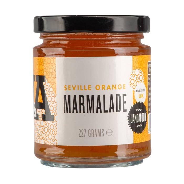 Janda Seville Orange Marmalade jar with orange slices and spread on bread, showcasing its vibrant color and chunky texture.
