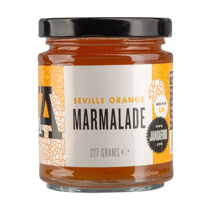 Janda Seville Orange Marmalade jar with orange slices and spread on bread, showcasing its vibrant color and chunky texture.