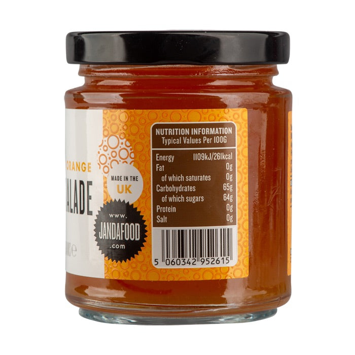 Janda Seville Orange Marmalade jar with slices of Seville oranges and a spoon on a wooden surface.