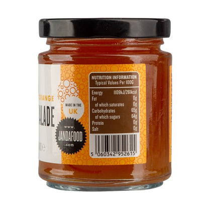 Janda Seville Orange Marmalade jar with slices of Seville oranges and a spoon on a wooden surface.