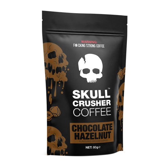 Ground Skull Crusher Coffee in Chocolate Hazelnut flavor, 80g package with a dark roasted coffee beans display.