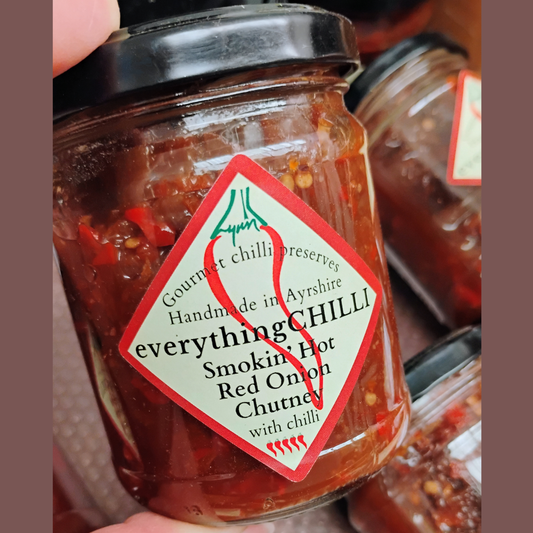 Spicy red onion chutney by everythingCHILLI with a rich, smoky appearance and vibrant red color in a jar.