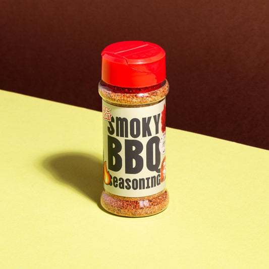 American smoky BBQ seasoning by The GOAT Seasoning Blends in a 75g shaker jar, featuring dark, smoky-colored spice blend.