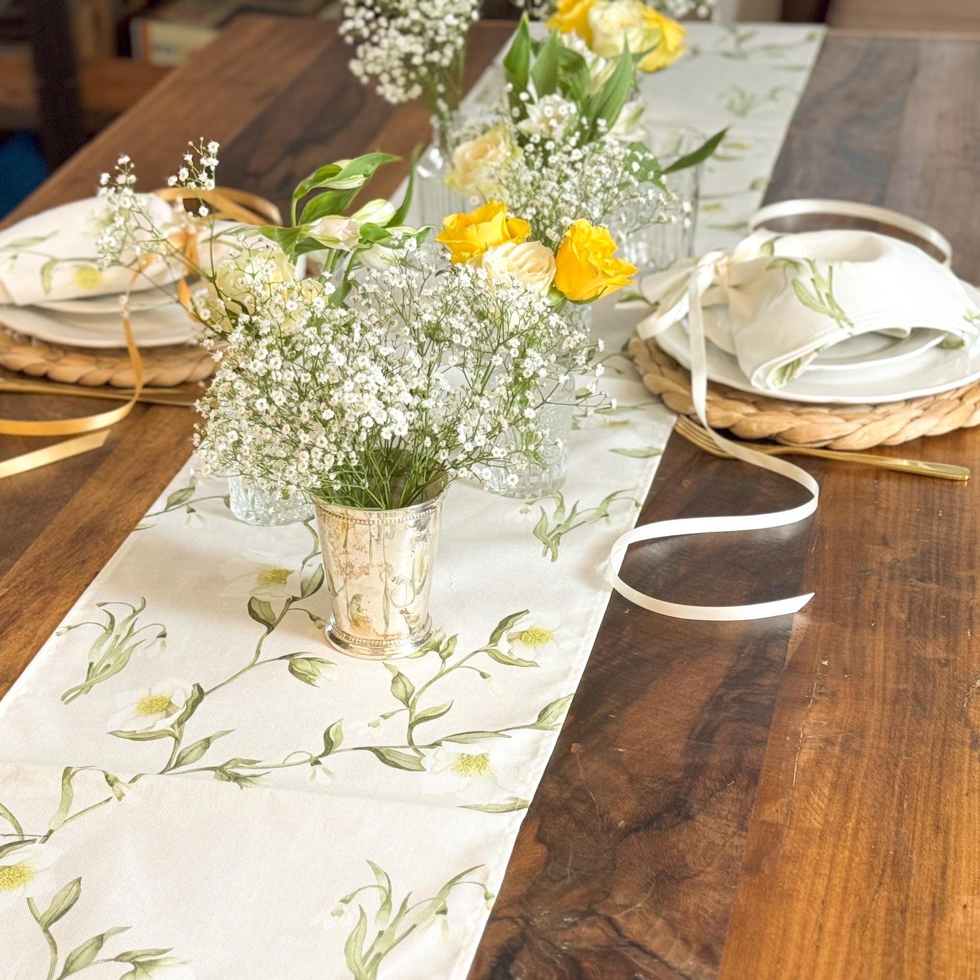Elegant table runner featuring snowdrops and hellebores floral design by Avalon Home UK, displayed on a wooden table.