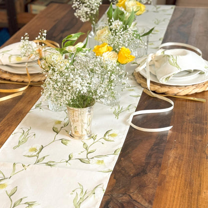 Elegant table runner featuring snowdrops and hellebores floral design by Avalon Home UK, displayed on a wooden table.