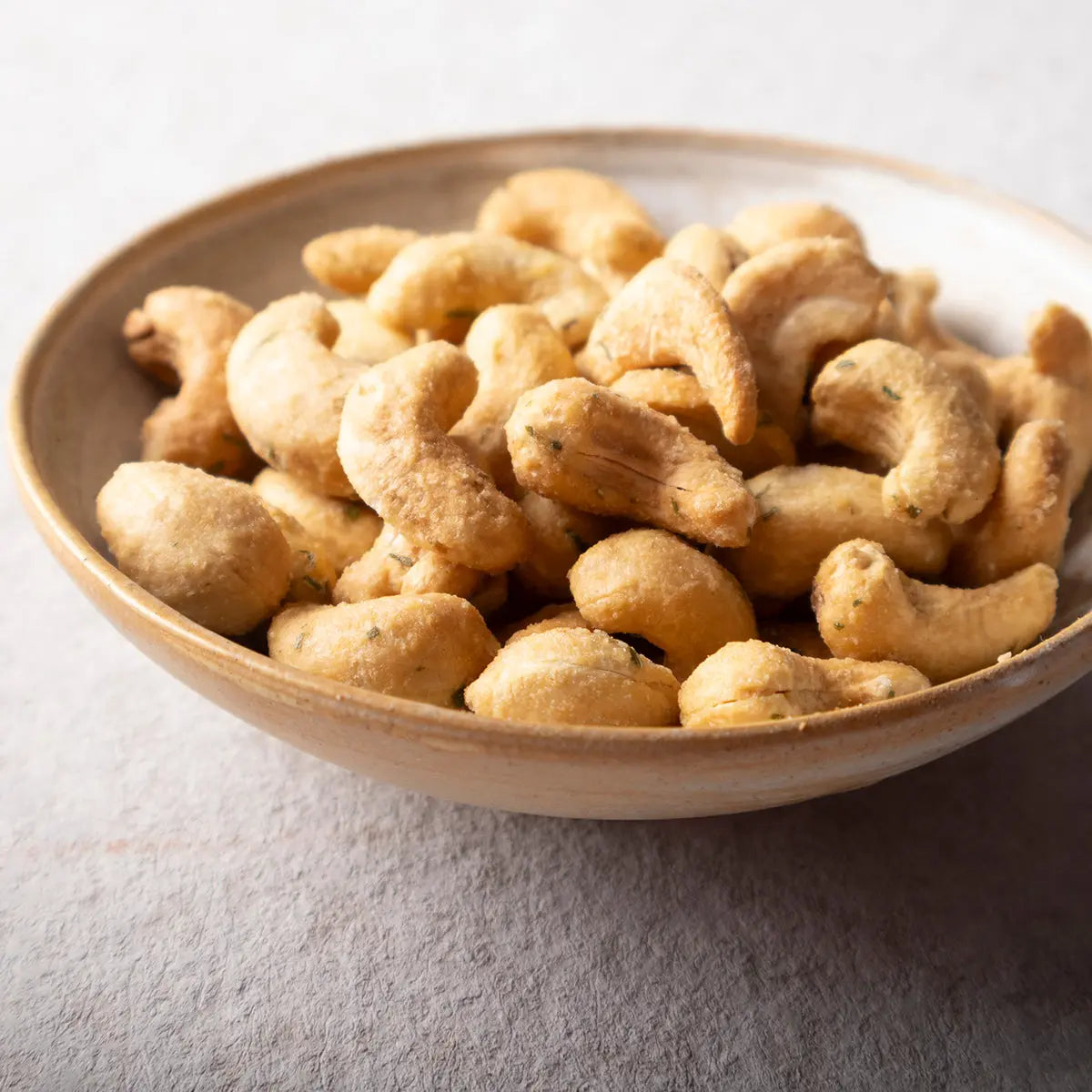 Bowl of Whole Food Earth sour cream and onion baked cashews, crunchy nuts and seeds snack with creamy onion flavor