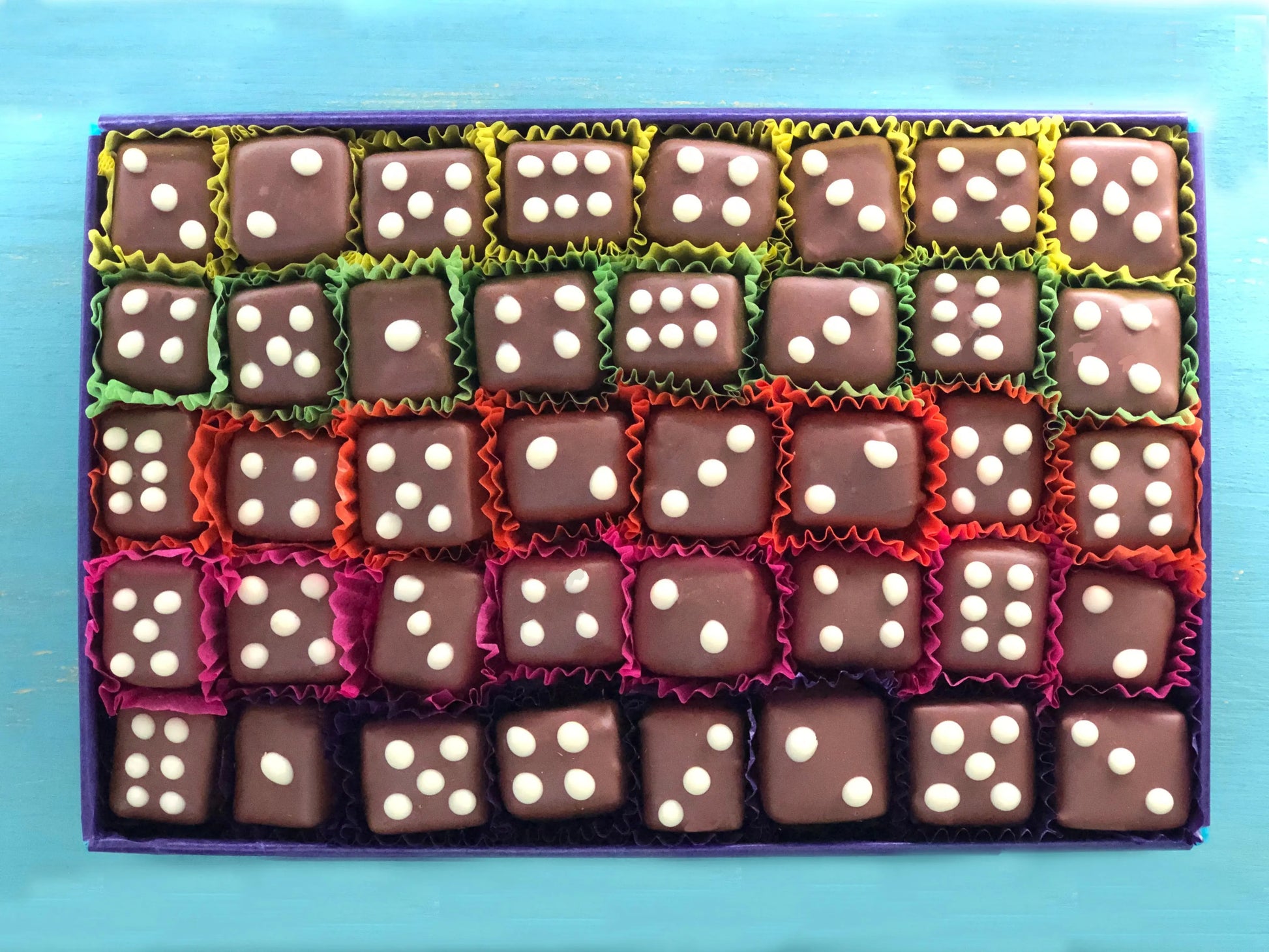 Gorvett & Stone Spiced Dice set featuring colorful, intricately designed dice with a warm, spicy tone on a dark background.