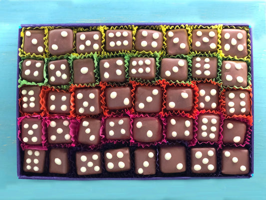 Gorvett & Stone Spiced Dice set featuring colorful, intricately designed dice with a warm, spicy tone on a dark background.