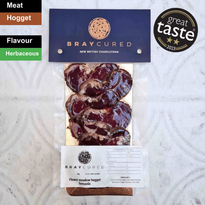 Thin slices of Bray Cured Hogget Bresaola charcuterie with a spicy flavor profile on a wooden serving board.