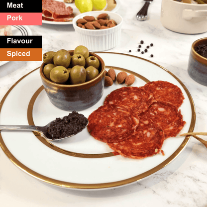 Spicy British chorizo slices from Bray Cured, showcasing vibrant red color and seasoned texture on a charcuterie board.
