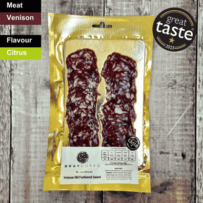 Spicy Bray Cured venison old-fashioned salami slices on a charcuterie board, showcasing rich, cured meat with spices.