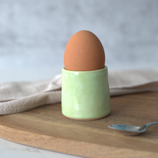 Spring green ceramic egg cup by Katie L Thompson Designs, featuring a classic, smooth design for serving eggs.