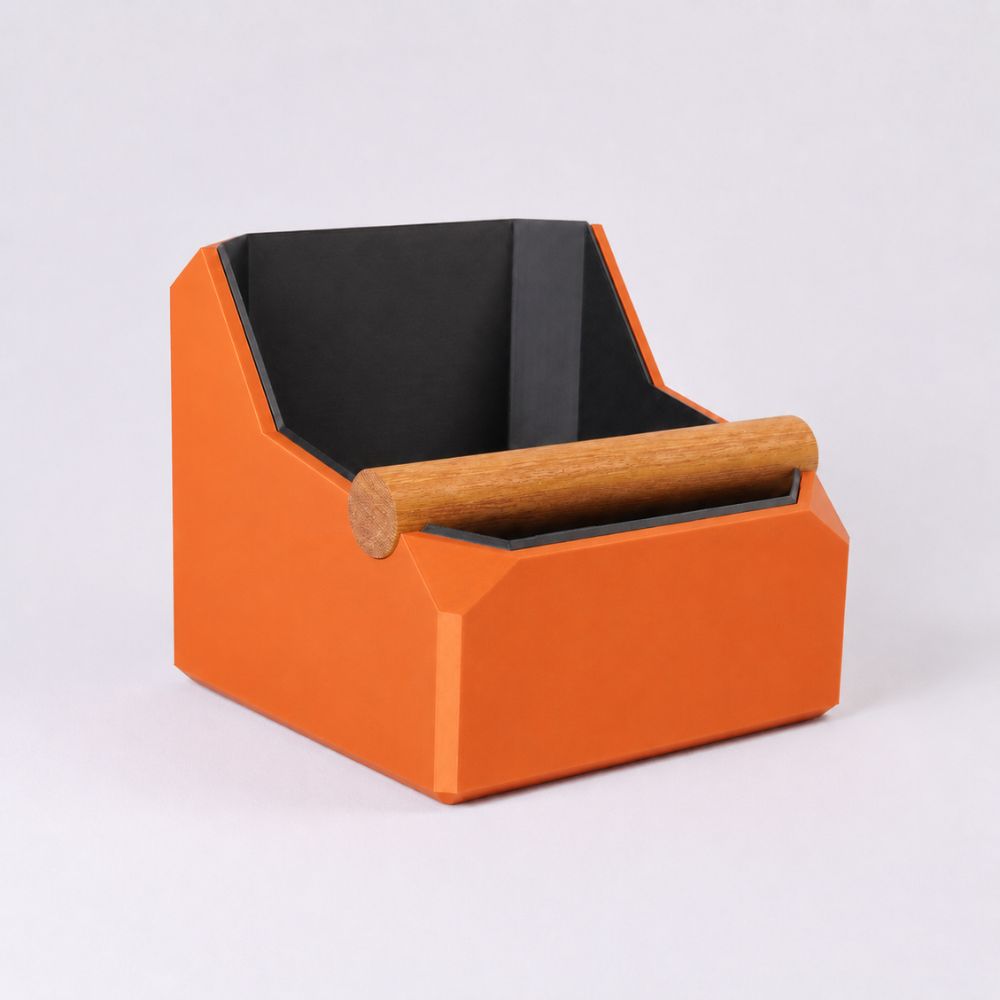 KNOCDIC® square coffee knock box with orange exterior and real oak knock bar for espresso machine cleanup.