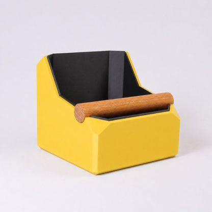 KNOCDIC® square coffee knock box with yellow finish and real oak knock bar, used for espresso coffee puck disposal.