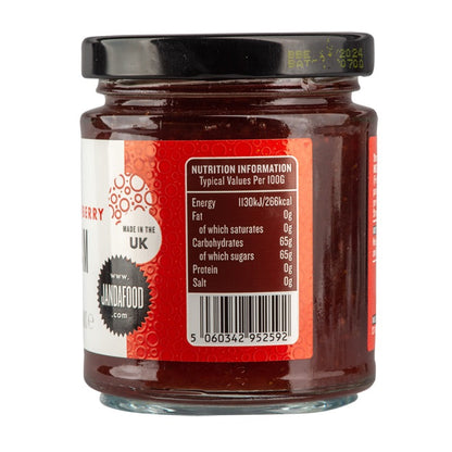 Jar of Janda strawberry jam with fresh strawberries around it, showcasing the bright red, chunky fruit spread.