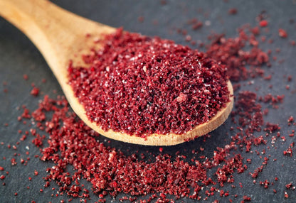 Whole Food Earth sumac spice in a jar, showcasing vibrant red, tangy seasoning for culinary use in seasonings and spice blends.