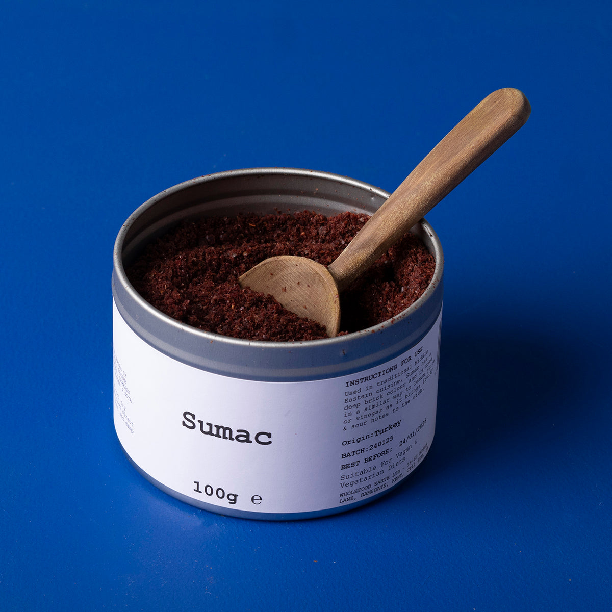 Dried wild elephant sumac spice in a 100g package, from Whole Food Earth, showcasing vibrant red spice grains.