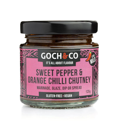 Goch & Co sweet pepper and orange chili chutney in a jar, showcasing vibrant orange and red colors with fresh ingredients.