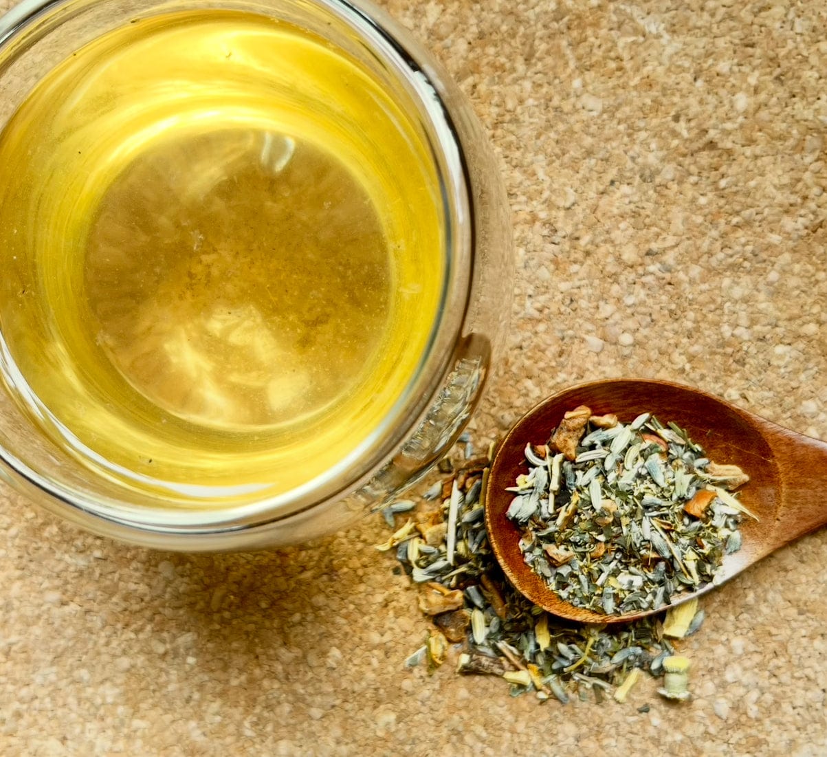 Porter Hill Tea Company's Sweet Dreams fruit and herbal sleep tea in a clear tea cup with herbs and fruit slices visible.