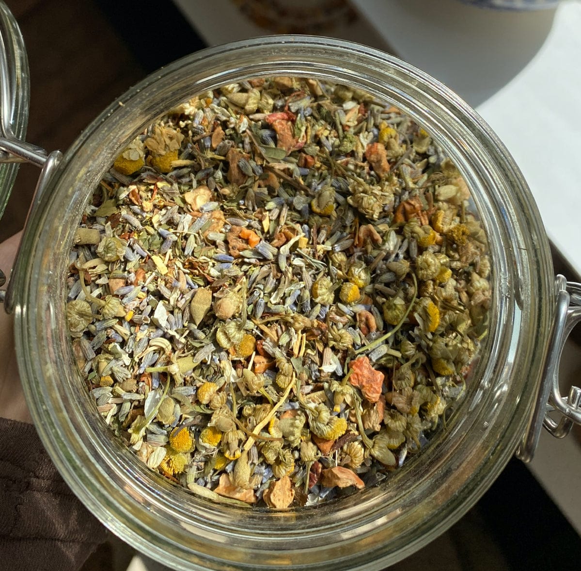 Porter Hill Tea Company's Sweet Dreams fruit and herbal tea in a cozy cup, featuring a blend of colorful herbs and fruit pieces.