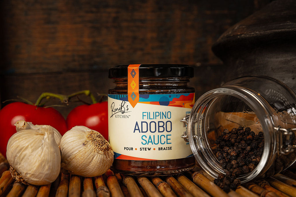 Bottle of RoniBs Kitchen Filipino Style Adobo Sauce, a rich, savory condiment used in Philippine cuisine.