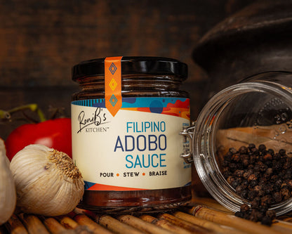 Filipino adobo sauce in a jar from RoniBs Kitchen, showcasing rich, dark condiment ideal for Filipino cuisine.
