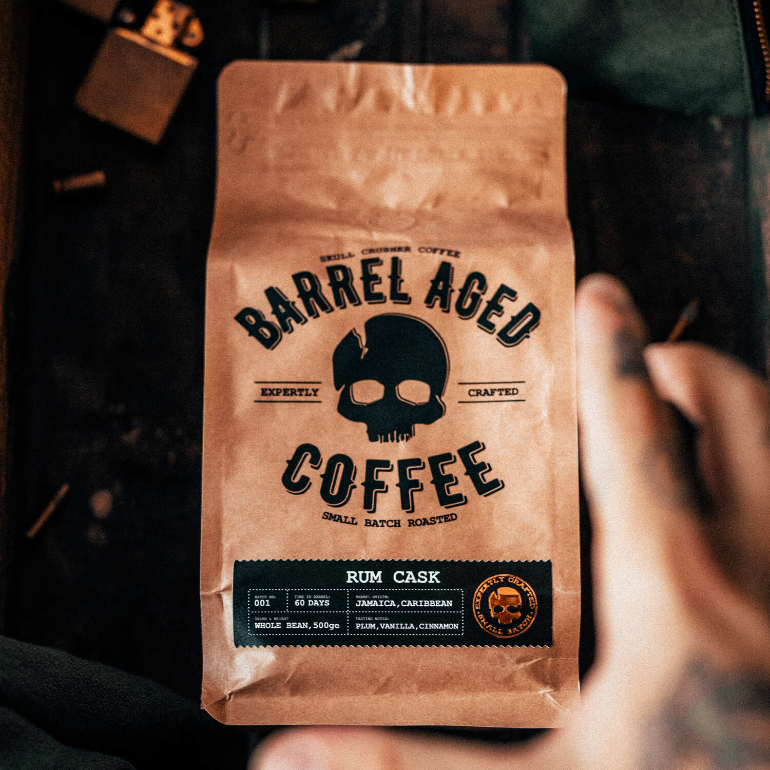 Barrel-aged Skull Crusher Coffee in a bag, showcasing the dark roasted beans and packaging for Skull Crusher Coffee Skull Crusher Coffee.