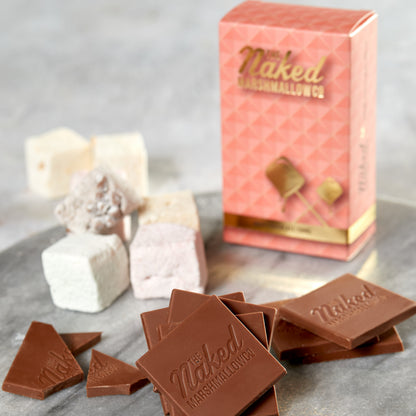 Naked marshmallow surrounded by milk chocolate thins from THE MARSHMALLOW FACTORY, close-up view of the snack.