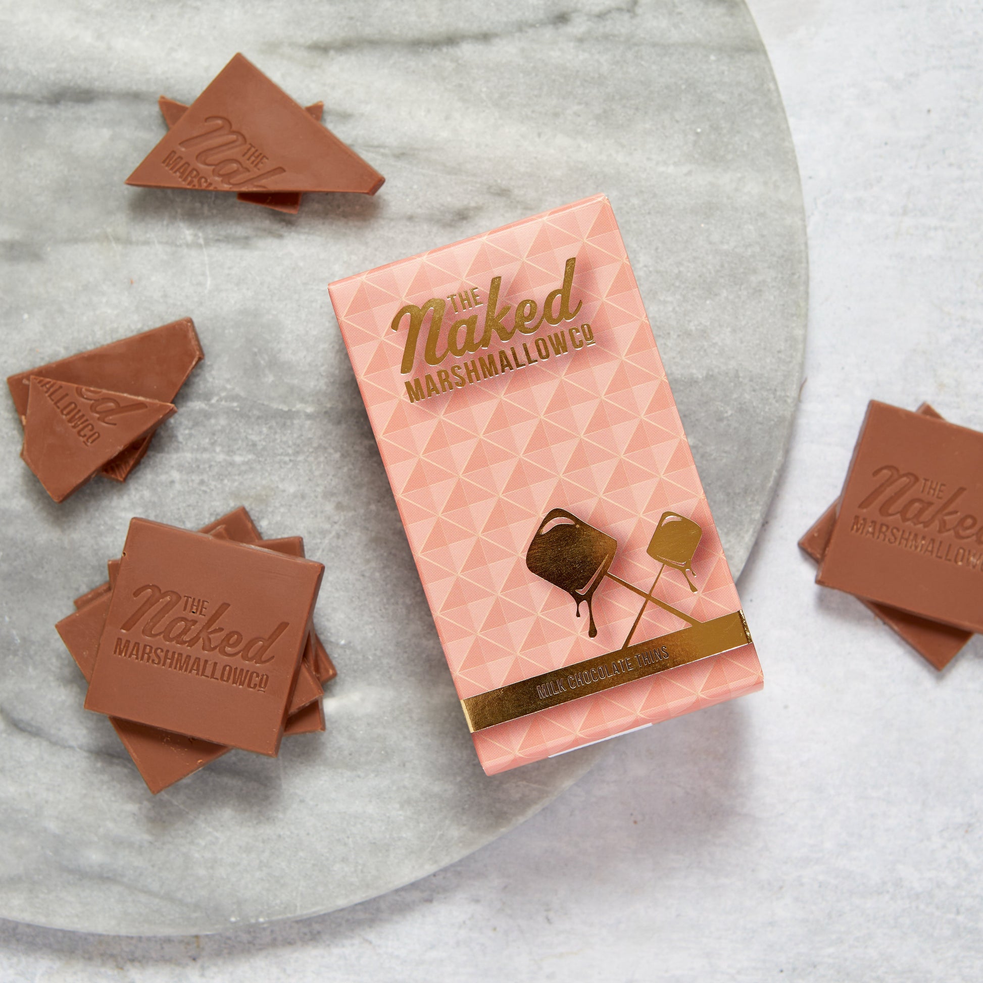 Naked marshmallow chocolate thins by THE MARSHMALLOW FACTORY, showcasing thin milk chocolate coating over fluffy marshmallow pieces