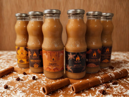 Six bottles of Ignite Coffee Co cold brew coffee tasting pack, showcasing different flavors in a wooden crate.