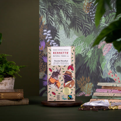 Bennetto Natural Foods UK toasted hazelnut chocolate bar with visible hazelnuts and smooth chocolate surface.