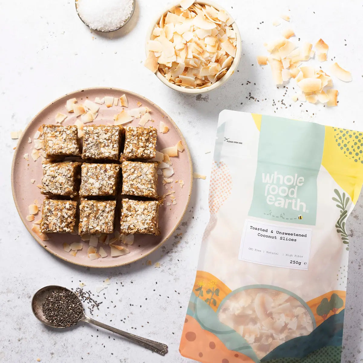 Toasted and unsweetened coconut slices from Whole Food Earth, showcasing golden-brown coconut pieces on a rustic surface.