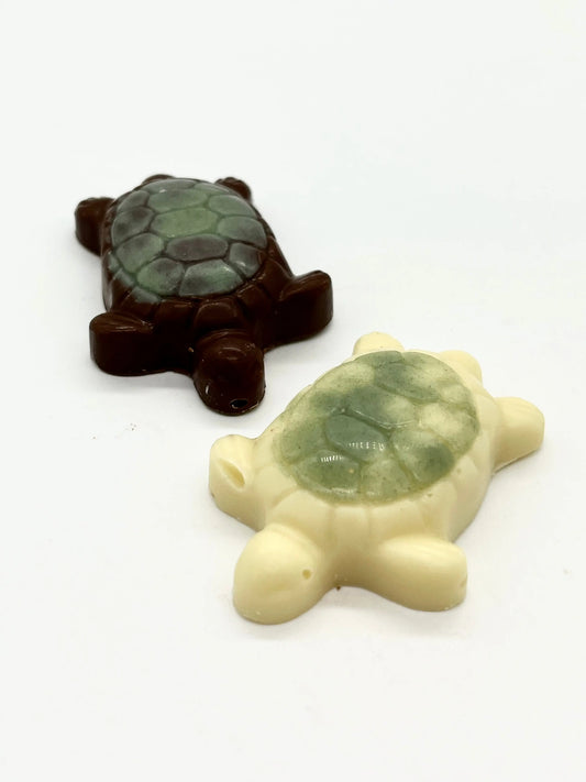 Gorvett & Stone turtles made of milk and white chocolate, shaped like realistic tortoises with detailed shells and limbs.