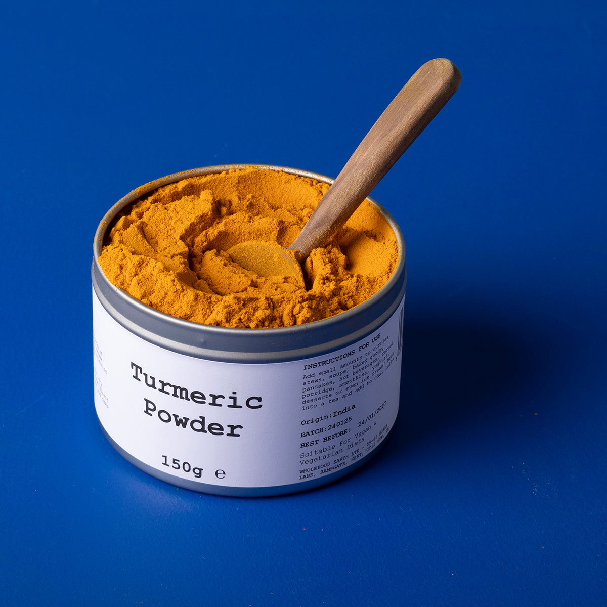 Ground turmeric powder from Wild Elephant, 150g, in a container, showcasing bright yellow spice from Whole Food Earth.