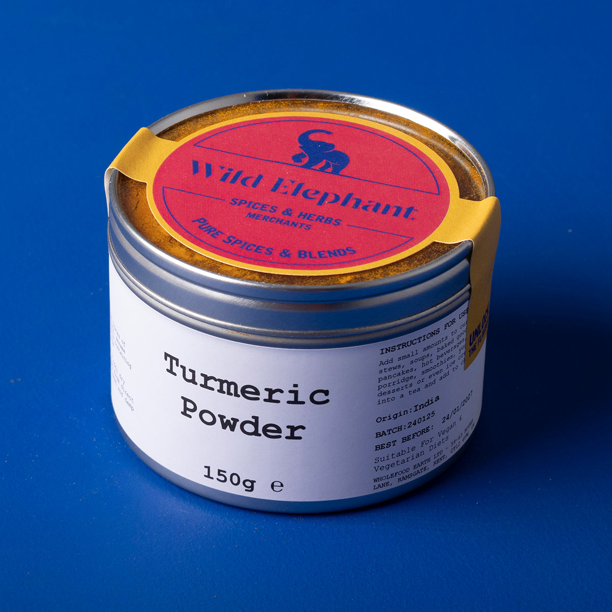 Golden yellow turmeric powder in a jar from Whole Food Earth, part of Wild Elephant herbs and spices collection.