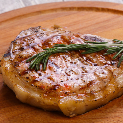 Cornish outdoor-reared Primrose Herd pork bacon chop, 500g, showing a raw bacon cut with marbled meat and crispy rind.