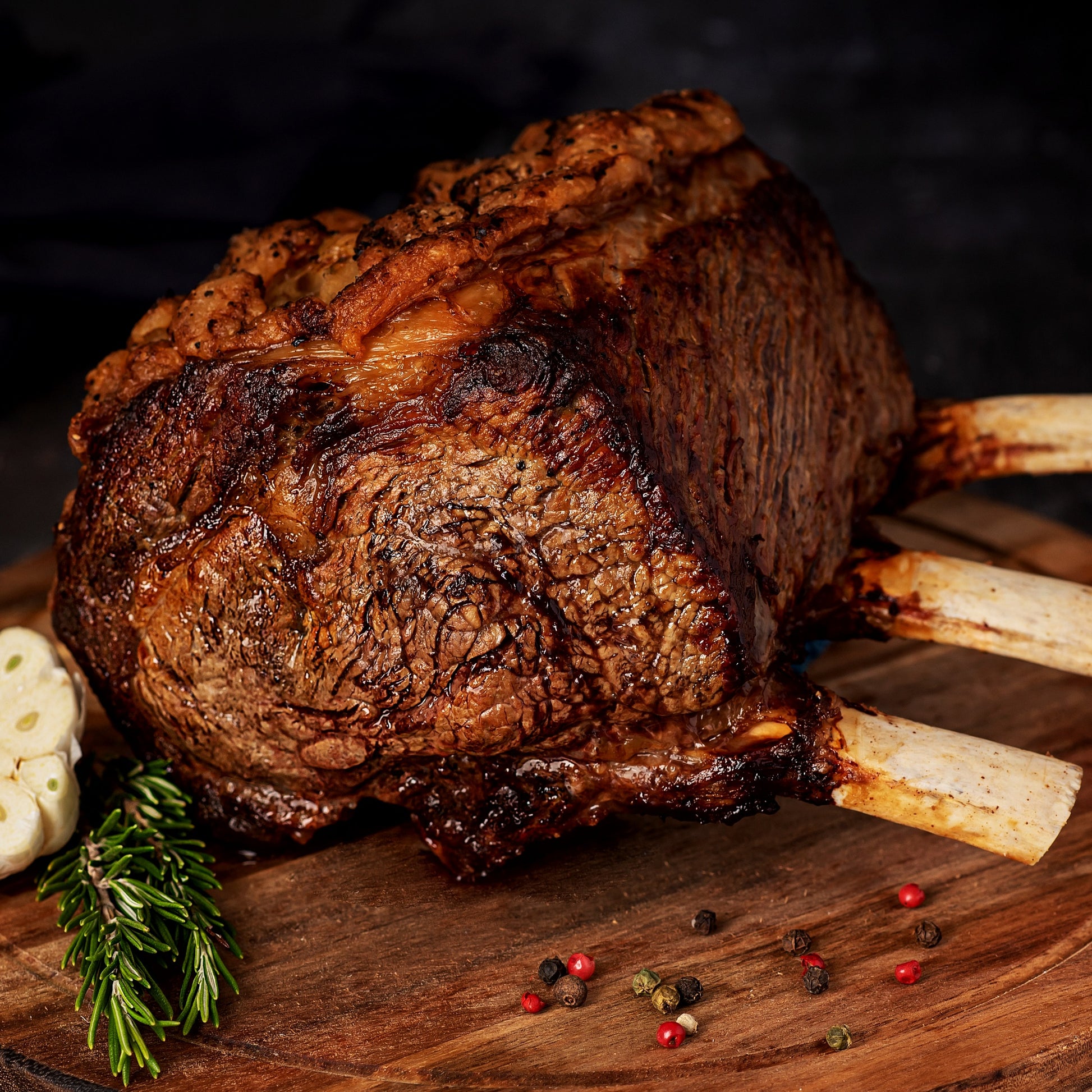 Primrose Herd Cornish dry-aged grass-fed beef rib joint, 2.5-5kg, showcasing a well-marbled, bone-in beef cut on a wooden surface.