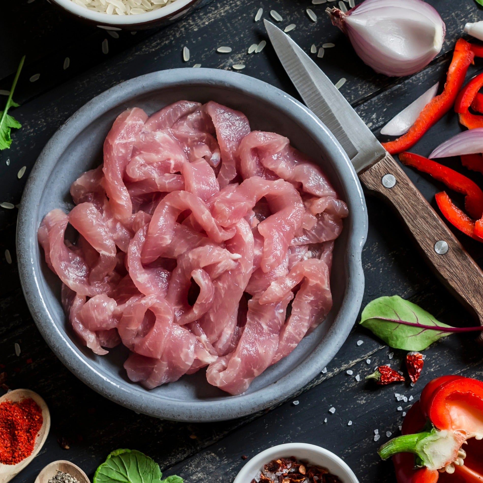 Cornish Heritage Pork Tenderloin Stir Fry Strips from Primrose Herd, 500g, raw pork tenderloin slices ready for cooking.