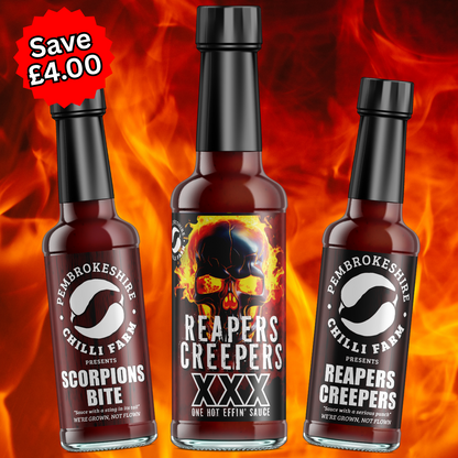 Three bottles of Pembrokeshire Chilli Farm hot sauce in various chili levels, showcasing vibrant labels and colorful sauce inside.