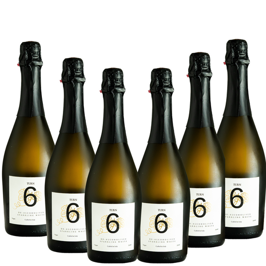 Six bottles of Turn 6 premium alcohol-free sparkling white wine in a case, showcasing clear, elegant bottles with white wine inside.
