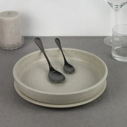 24-piece Pintinox Drop Black cutlery set from Glassware UK, including knives, forks, and spoons arranged on a table.
