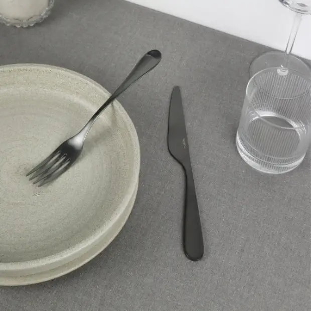 Black Pintinox Drop 24-piece cutlery set from Glassware UK, featuring sleek stainless steel utensils with black handles.