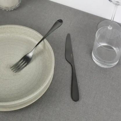 Black Pintinox Drop 24-piece cutlery set from Glassware UK, featuring sleek stainless steel utensils with black handles.