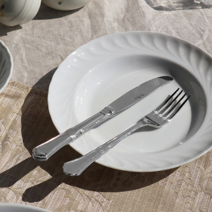 Glassware UK Pintinox Settecento table fork in mirror polish, showcasing a sleek, polished cutlery design with four tines.