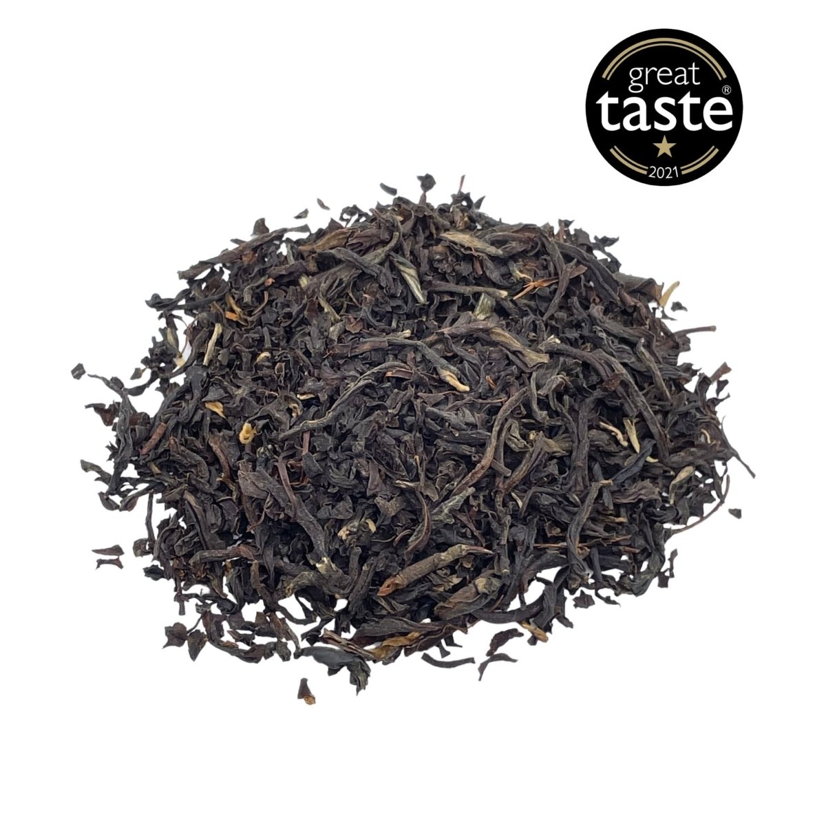 Loose leaf English Breakfast tea by Camellios with dark tea leaves and a rustic tea tin in the background.